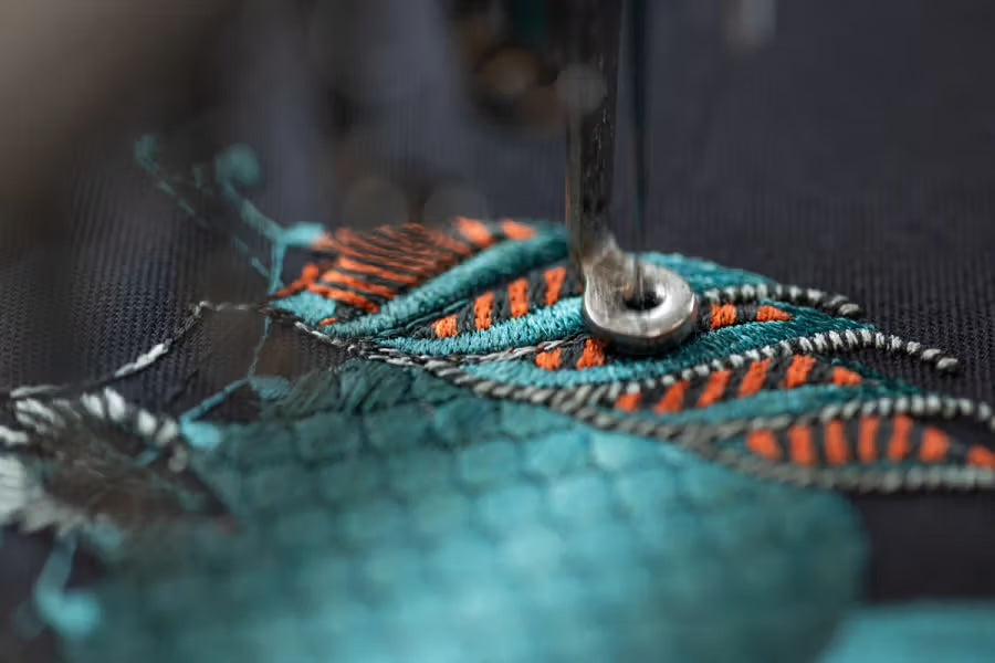 Macro detail of embroidery stitched in gradient-coloured thread